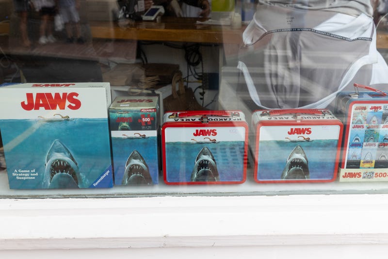 EDGARTOWN, MASSACHUSETTS - JUNE 18: Jaws merchandise is displayed in a store window on June 18, 2025 in Edgartown, Massachusetts. The area where much of the movie was filmed is celebrating the 50th anniversary of the release of the motion picture "Jaws." (Photo by Matt Cosby/Getty Images)