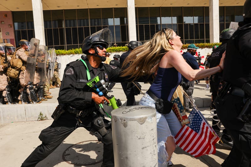 police officer pushing running woman