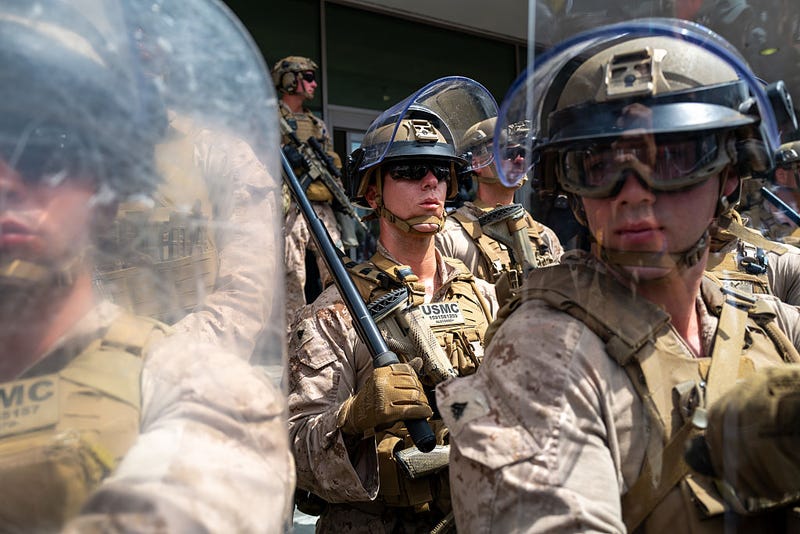 U.S. Marines are confronted by protesters outside a federal building in during an anti-Trump "No Kings Day" demonstration in a city that has been the focus of protests against Trump's immigration raids on June 14, 2025 in Los Angeles, California