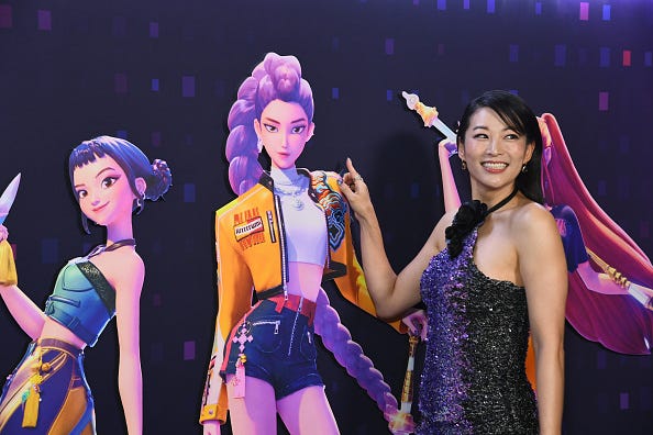 Arden Cho poses on the red carpet in front of her KPop Demon Hunter character