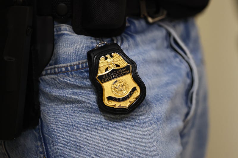 An ICE badge on an ICE agent.