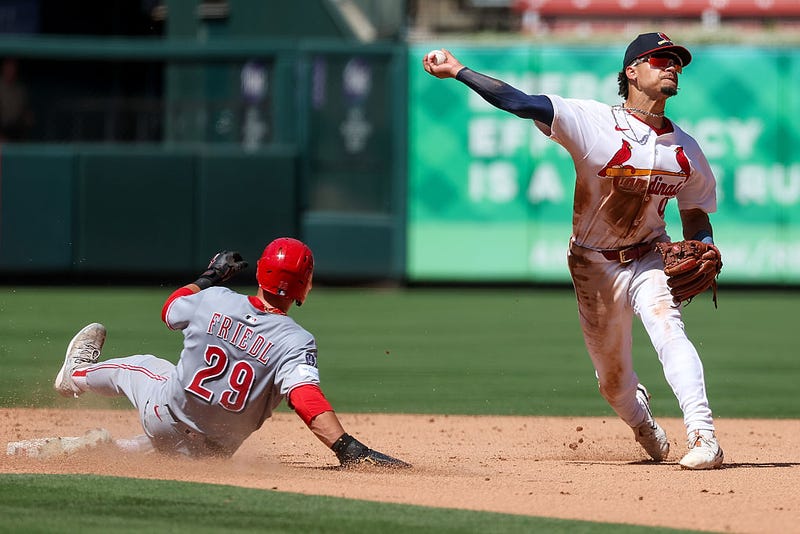 Masyn Winn #0 of the St. Louis Cardinals turns a double play over TJ Friedl #29 of the Cincinnati Reds during the eighth inning at Busch Stadium on June 22, 2025 in St Louis, Missouri.
