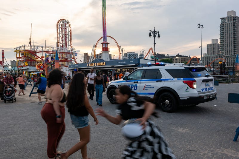 The NYPD patrols Coney Island, near Luna Park, this summer