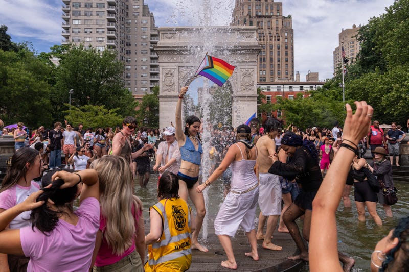 People cool off in the fountain at Washington Square park after the 2025 NYC Pride March on June 29, 2025