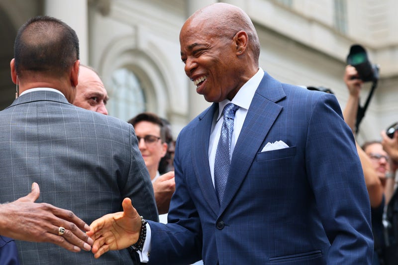 Mayor Eric Adams arrives for a press conference at City Hall this summer