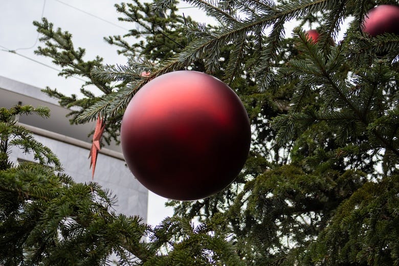 Big red ball hanging on a Christmas tree