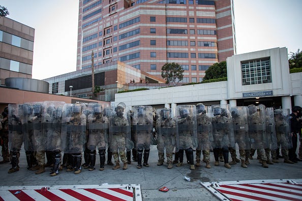 U.S. Marines stand guard at the Edward R. Roybal Federal and Detention Center building during a protest against U.S. Immigration and Customs Enforcement (ICE) raids and the presence of the U.S. military in civilian spaces on July 4, 2025 in Los Angeles, California. The demonstration on Independence Day drew activists and community members to the streets, calling for immigration reform and demilitarization. (Photo by Apu Gomes/Getty Images)