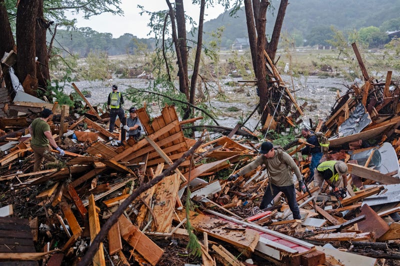  Search and rescue workers dig through debris looking for any survivors or remains of people swept up in the flash flooding on July 6, 2025 in Hunt, Texas. 