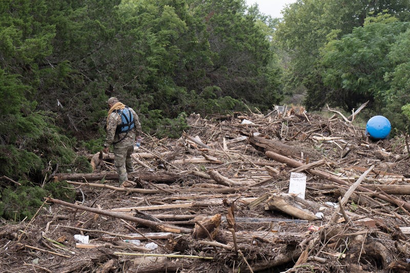 KERRVILLE, TEXAS - JULY 06: U.S. Border Patrol officers search through flood debris along the Guadalupe River on July 6, 2025 in Kerrville, Texas. At least 80 people died in catastrophic flooding across central Texas after heavy rainfall on July 4th caused the Guadalupe River to overflow its banks. (Photo by Eric Vryn/Getty Images)