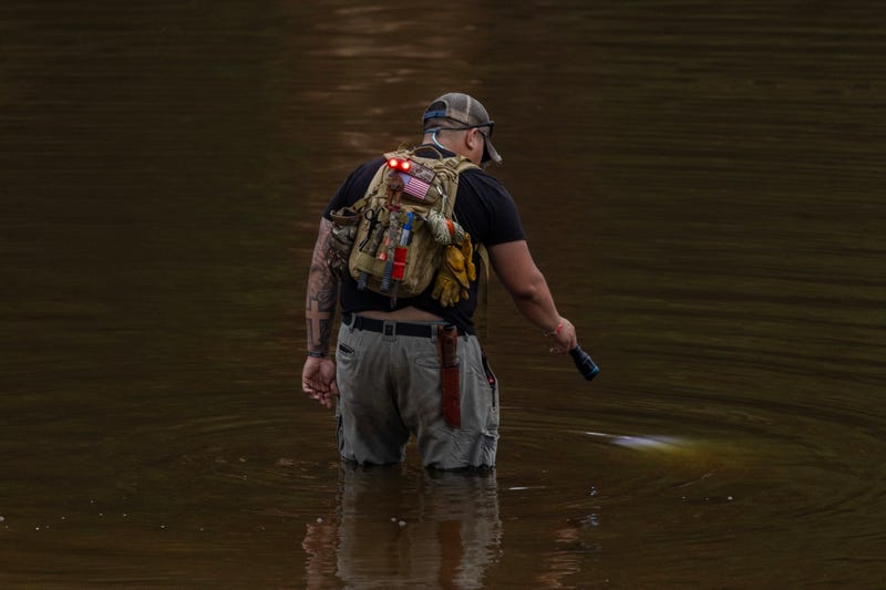 HUNT, TEXAS - JULY 6: A search and recovery worker shines his flashlight through through murky waters near Camp Mystic, looking for remains of victims on July 6, 2025 in Hunt, Texas. Heavy rainfall caused flooding along the Guadalupe River in central Texas with multiple fatalities reported. (Photo by Jim Vondruska/Getty Images)