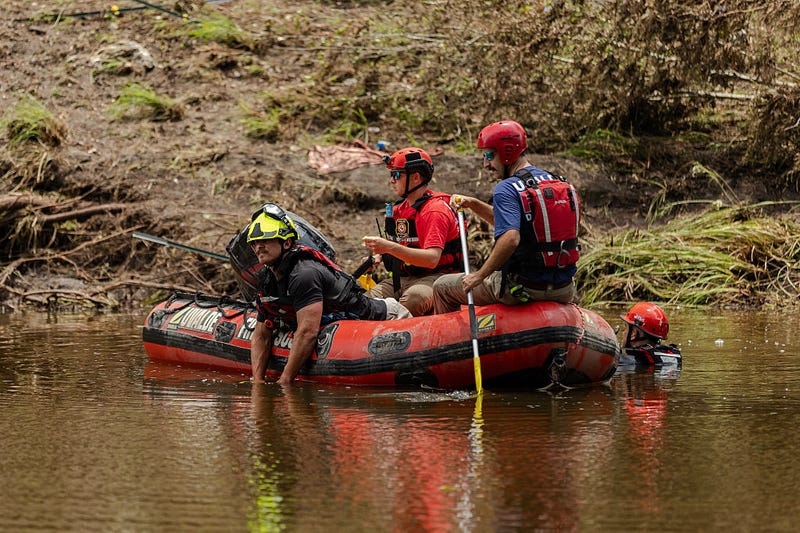 Search and rescue workers use a sonar device while paddling down the Guadalupe River looking for survivors or the remains of victims swept up in the flash flooding on July 7, 2025