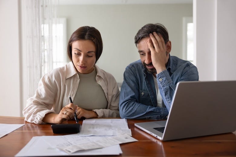 Stressed couple working on their finances