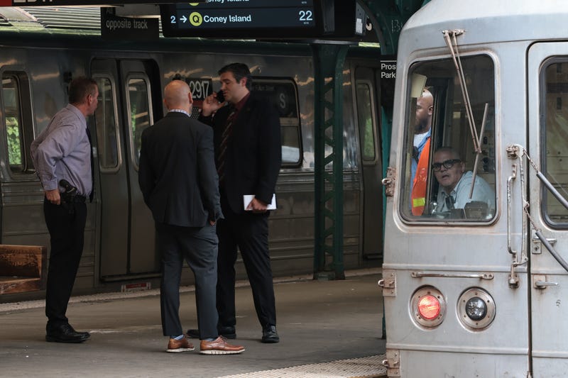 NYPD officers investigate the scene of a man hit by a train at the Prospect Park subway stop on July 30, 2025