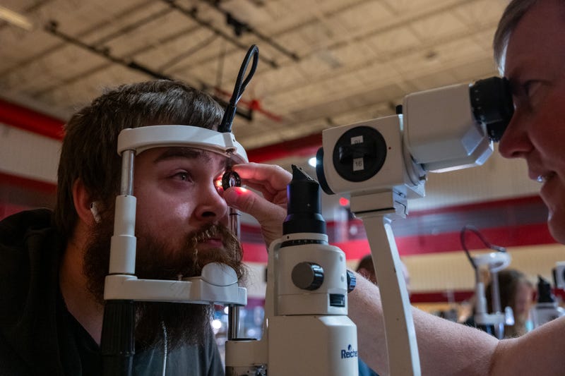Gabriel Drapper, who currently doesn't have health insurance, takes a vision test for a new pair of glasses at a Remote Area Medical (RAM) mobile dental and medical clinic at Terre Haute South High School on August 02, 2025 in Terre Haute, Indiana. An estimated 27 million people — or 8.3 percent of the population — are uninsured, according to a report from the Census Bureau, with the rate considerably higher in rural and poorer parts of the country. 