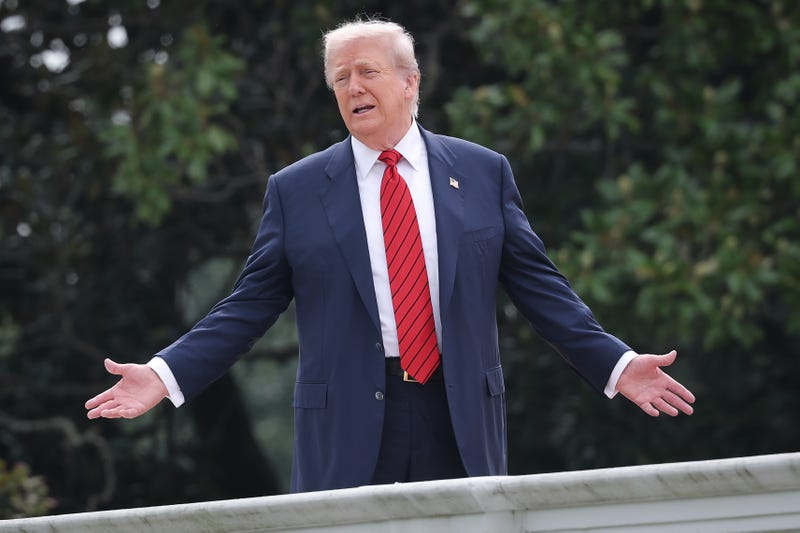 President Donald Trump gestures while answering questions from reporters as he tours the roof of the West Wing of the White House on August 5, 2025