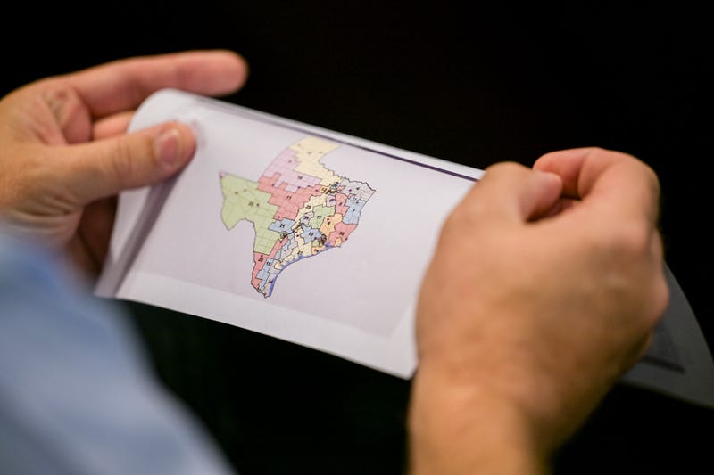 AUSTIN, TEXAS - AUGUST 07: A person views a map during a Senate Special Committee on Congressional Redistricting public testimony hearing on August 07, 2025 in Austin, Texas. The Senate Special Committee on Congressional Redistricting met to hear public testimony on Congressional plan C2308. Earlier this week, Texas Democratic lawmakers fled the state in an attempt to protest and deny quorum for votes on the proposed Republican redistricting plan, which would secure five additional GOP seats in the U.S. House. Gov. Greg Abbott has threatened to remove lawmakers who do not return and has asked the Texas Supreme Court to expel House Democratic leaders who fled the state. (Photo by Brandon Bell/Getty Images)