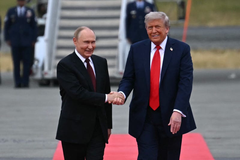 President Donald Trump (R) shakes hands with greets Russian President Vladimir Putin on the tarmac after they arrived at Joint Base Elmendorf-Richardson in Anchorage, Alaska, on August 15, 2025