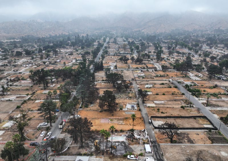 In an aerial view, U.S. Army Corps of Engineers contractors clear wildfire debris from the destroyed historic home (LOWER C) of late Los Angeles arts legend John Outterbridge, which burned in the Eaton Fire, on August 15, 2025 in Altadena, California. 