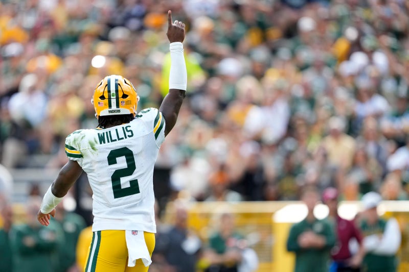 Malik Willis #2 of the Green Bay Packers celebrates after throwing a touchdown pass in the first quarter during the NFL Preseason 2025 game between Seattle Seahawks and Green Bay Packers at Lambeau Field on August 23, 2025 in Green Bay, Wisconsin. 
