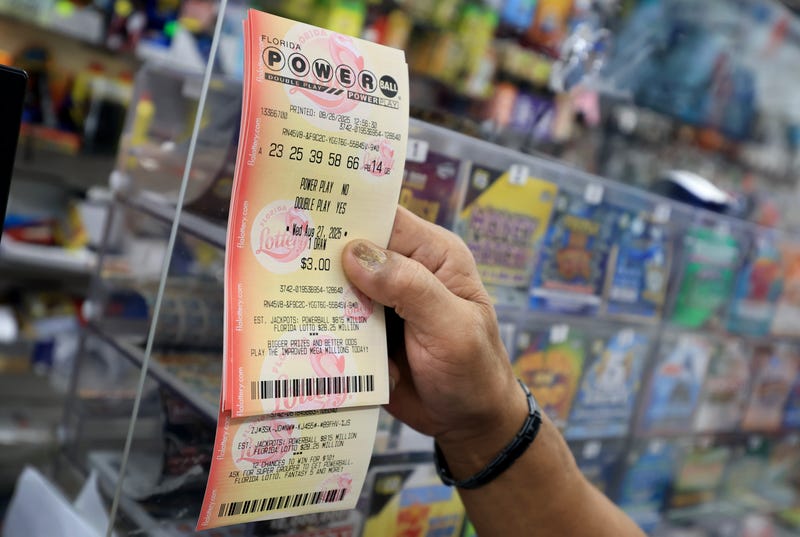 MIAMI, FLORIDA - AUGUST 26: A customer holds a Powerball lottery ticket after purchasing it at the Downtown Miami Souvenirs store on August 26, 2025 in Miami, Florida. The Powerball jackpot has climbed to $815 million ahead of Wednesday's drawing, making the jackpot the 10th-largest in Powerball history. (Photo by Joe Raedle/Getty Images)