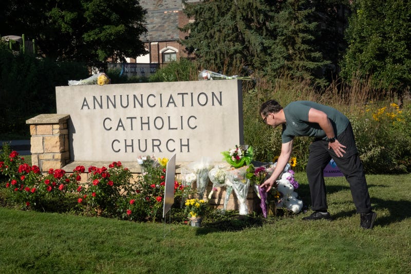 People visit a memorial to yesterday's shooting victims in front of Annunciation Catholic Church on August 28, 2025 in Minneapolis, Minnesota.