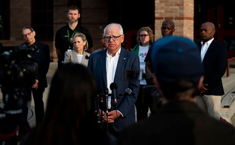 Minnesota Gov. Tim Walz (C) speaks to media gathered on the first day of school at Deerwood Elementary on September 2, 2025 in Eagan, Minnesota. 