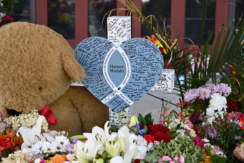  A cross with the name of 10-year-old shooting victim Harper Moyski is seen amid flowers at Annunciation Catholic Church on September 3, 2025 in Minneapolis, Minnesota. The shooting left two students dead and many more wounded. 