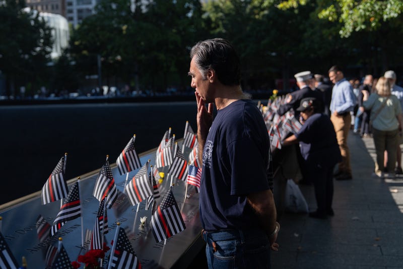 A person blows a kiss as he looks at names on the south reflecting pool during the annual 9/11 Commemoration Ceremony at the National 9/11 Memorial and Museum on September 11, 2025