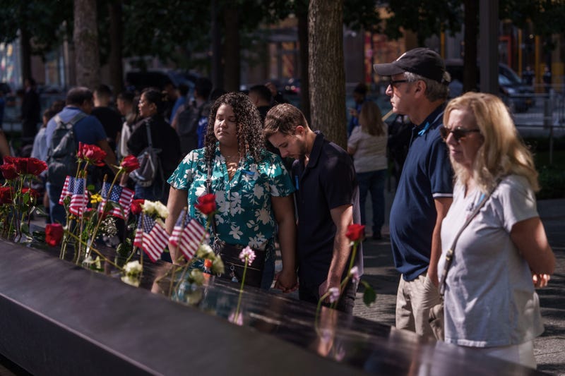 Cole Santiago (center) and his wife Raysa Santiago, pay their respects for his aunt Anna Laverty, who was killed in the South Tower, during the annual 9/11 Commemoration Ceremony at the National 9/11 Memorial and Museum on Sept. 11, 2025
