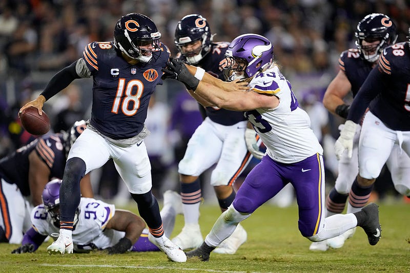 Caleb Williams #18 of the Chicago Bears stiff arms Andrew Van Ginkel #43 of the Minnesota Vikings during the game at Soldier Field on September 08, 2025 in Chicago, Illinois. 