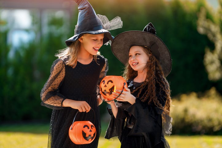 girls in witch costumes