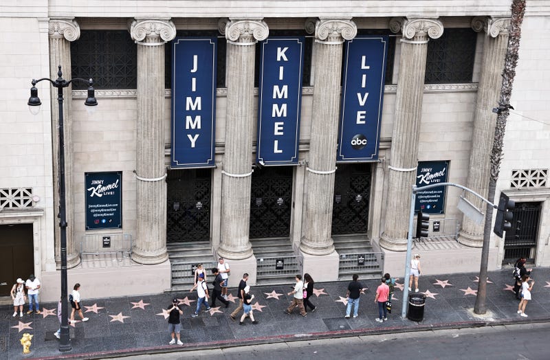 People walk outside the El Capitan Entertainment Centre where the "Jimmy Kimmel Live!" show is performed in Hollywood on September 18, 2025 in Los Angeles, California. 