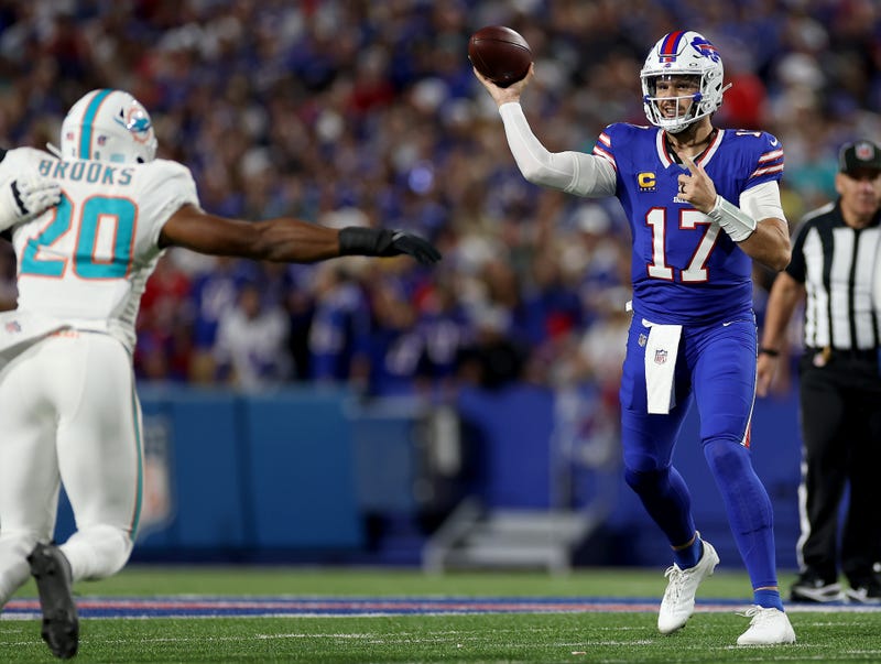 Josh Allen makes a pass against Jordyn Brooks