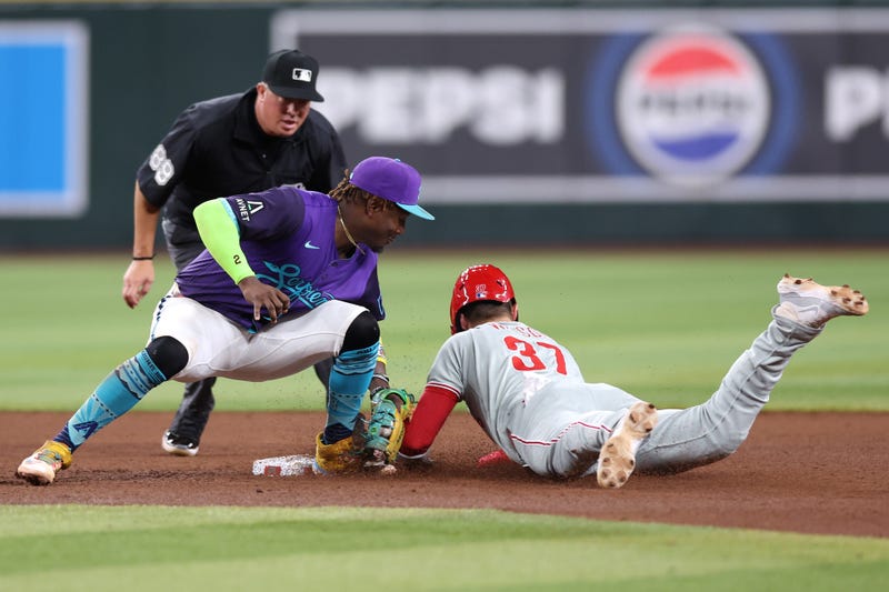 Weston Wilson #37 of the Philadelphia Phillies is tagged out attempting to steal second base by Geraldo Perdomo #2 of the Arizona Diamondbacks during the sixth inning at Chase Field on September 19, 2025