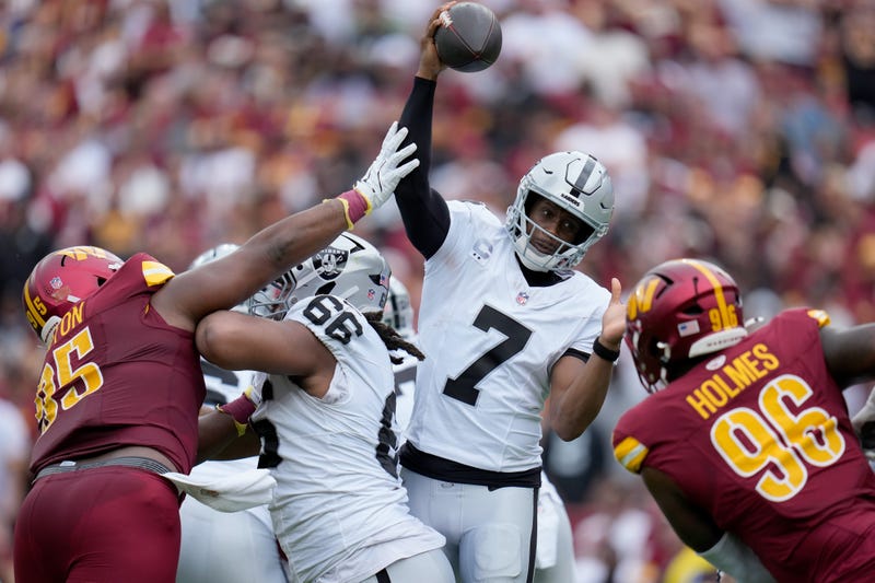 Jer'Zhan Newton #95 of the Washington Commanders puts pressure on Geno Smith #7 of the Las Vegas Raiders during the second quarter at Northwest Stadium on September 21, 2025 in Landover, Maryland. 