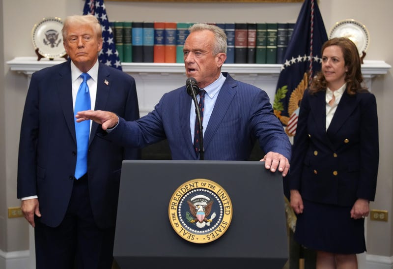 President Donald Trump, left, and Health and Human Services Secretary Robert F. Kennedy Jr., center.