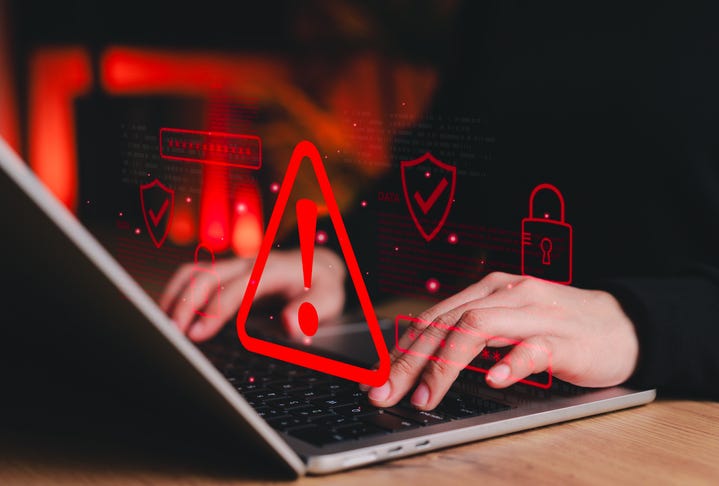cybersecurity concept art. hand on laptop computer, red warning symbols. 