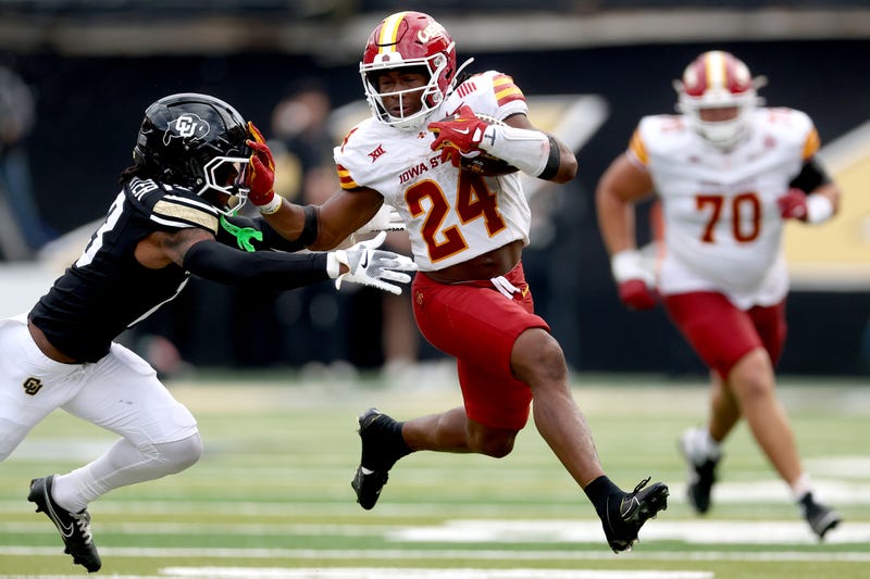 Abu Sama III #24 of the Iowa State Cyclones carries the ball against John Slaughter #13 of the Colorado Buffaloes in the third quarter at Folsom Field on October 11, 2025 in Boulder, Colorado.