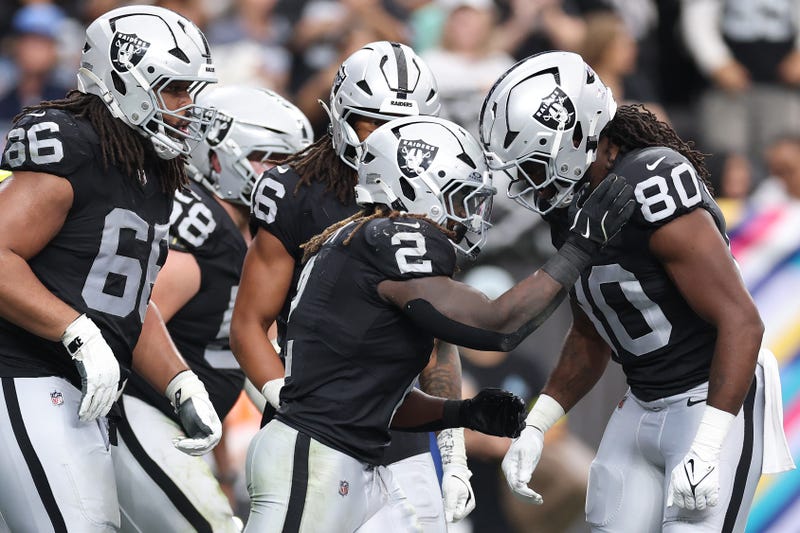Ashton Jeanty #2 of the Las Vegas Raiders celebrates after his rushing touchdown against the Tennessee Titans with Ian Thomas #80 during the third quarter in the game at Allegiant Stadium on October 12, 2025 in Las Vegas, Nevada.