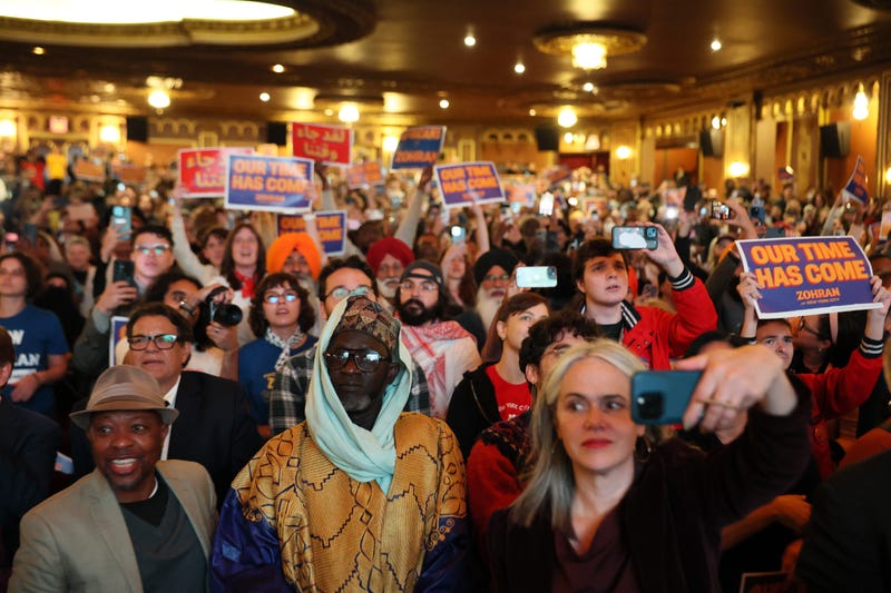 Supporters of New York City Mayoral candidate Zohran Mamdani hold campaign signs during a campaign rally at United Palace on October 13, 2025