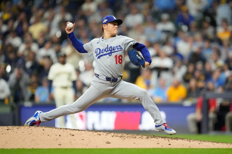 Yoshinobu Yamamoto #18 of the Los Angeles Dodgers pitches during the eighth inning against the Milwaukee Brewers in game two of the National League Championship Series at American Family Field on October 14, 2025 in Milwaukee, Wisconsin.