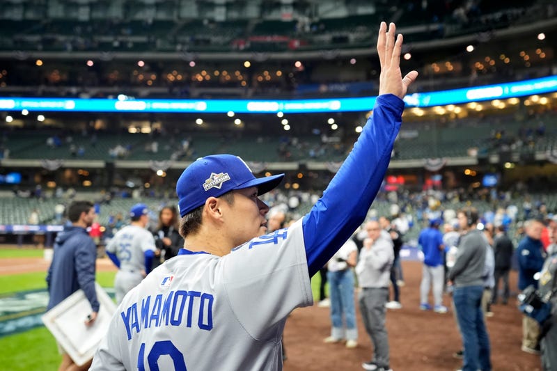 Yoshinobu Yamamoto #18 of the Los Angeles Dodgers waves to the crowd after beating the Milwaukee Brewers 5-1 in game two of the National League Championship Series at American Family Field on October 14, 2025 in Milwaukee, Wisconsin. 