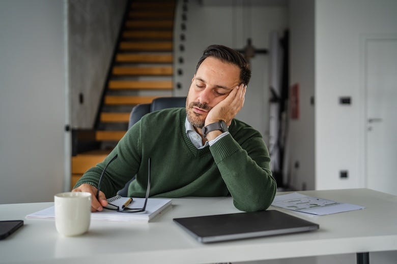 Tired businessman sleeping at his desk