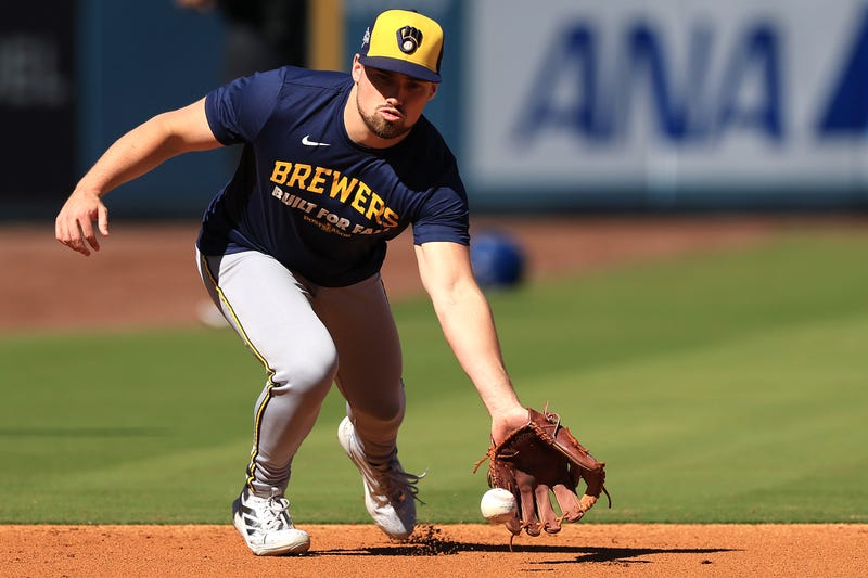 Caleb Durbin #21 of the Milwaukee Brewers warms up before facing the Los Angeles Dodgers in game three of the National League Championship Series at Dodger Stadium on October 16, 2025 in Los Angeles, California