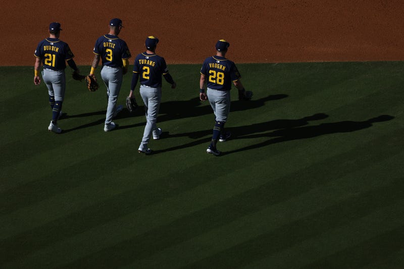 Caleb Durbin #21, Joey Ortiz #3, Brice Turang #2, and Andrew Vaughn #28 of the Milwaukee Brewers walk on the infield after a mound visit in the second inning against the Los Angeles Dodgers in game three of the National League Championship Series at Dodger Stadium on October 16, 2025 in Los Angeles, California