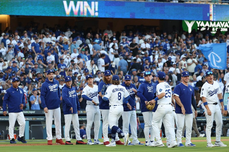The Los Angeles Dodgers react after defeating the Milwaukee Brewers 3-1 in game three of the National League Championship Series at Dodger Stadium on October 16, 2025 in Los Angeles, California.