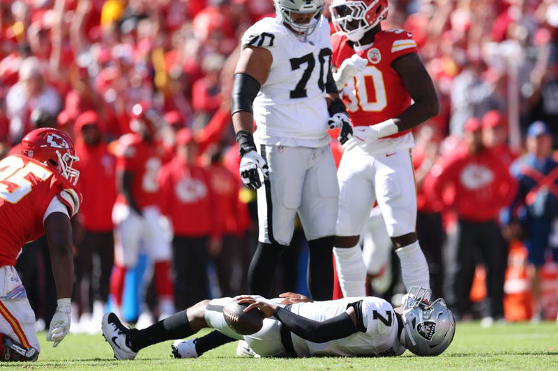 Geno Smith #7 of the Las Vegas Raiders reacts after a sack by Chris Jones #95 of the Kansas City Chiefs during the third quarter in the game at Arrowhead Stadium on October 19, 2025 in Kansas City, Missouri.