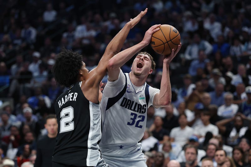 DALLAS, TEXAS - OCTOBER 22: Cooper Flagg #32 of the Dallas Mavericks is fouled by Dylan Harper #2 of the San Antonio Spurs during the second half at American Airlines Center on October 22, 2025 in Dallas, Texas. NOTE TO USER: User expressly acknowledges and agrees that, by downloading and or using this photograph, User is consenting to the terms and conditions of the Getty Images License Agreement. (Photo by Stacy Revere/Getty Images)