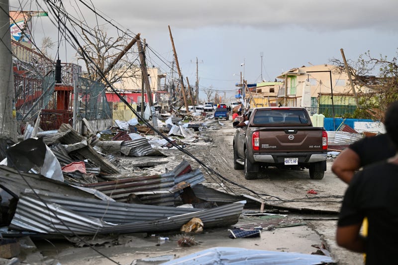 A car drives through a destroyed neighborhood following the passage of Hurricane Melissa in Black River, Jamaica, Oct. 29, 2025. 