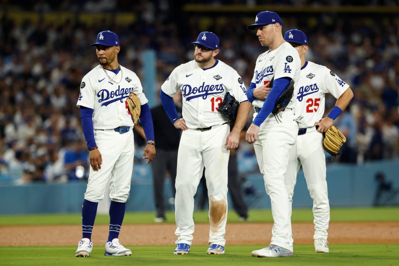Mookie Betts #50, Max Muncy #13, Freddie Freeman #5 and Tommy Edman #25 of the Los Angeles Dodgers look on during a pitching change as Blake Treinen #49 (not pictured) enters the game as they take on the Toronto Blue Jays in game four of the 2025 World Series at Dodger Stadium on October 28, 2025 in Los Angeles, California.
